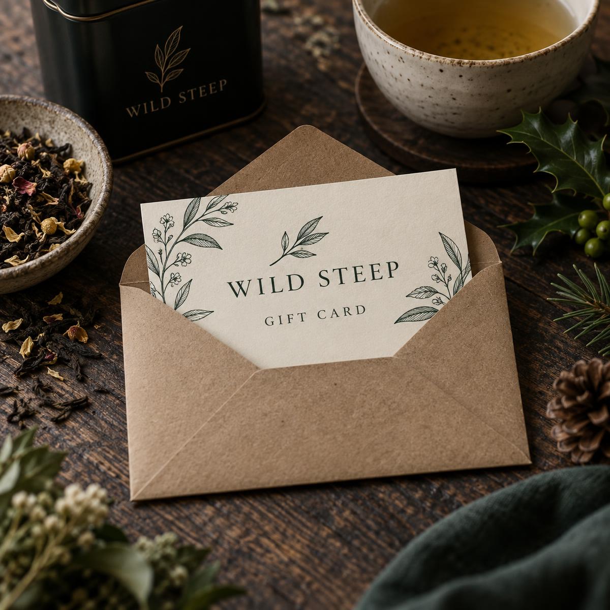 Wild Steep gift card in a kraft envelope beside loose leaf tea and a ceramic cup
